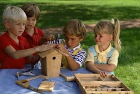 group of kids building a wooden bird house